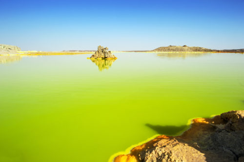 The volcanic explosion crater of Dallol in the Danakil Depresseion in Nothern Ethiopia. The Dallol crater was formed during a phreatic eruption in 1926. This crater is known as the lowest subaerial vulcanic vents in the world. The surreal colours are caused by green acid ponds and iron oxides and sulfur.