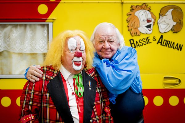 Bassie en Adriaan van Toor voor hun gele caravan.