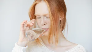 Vrouw drinkt glas met prikwater
