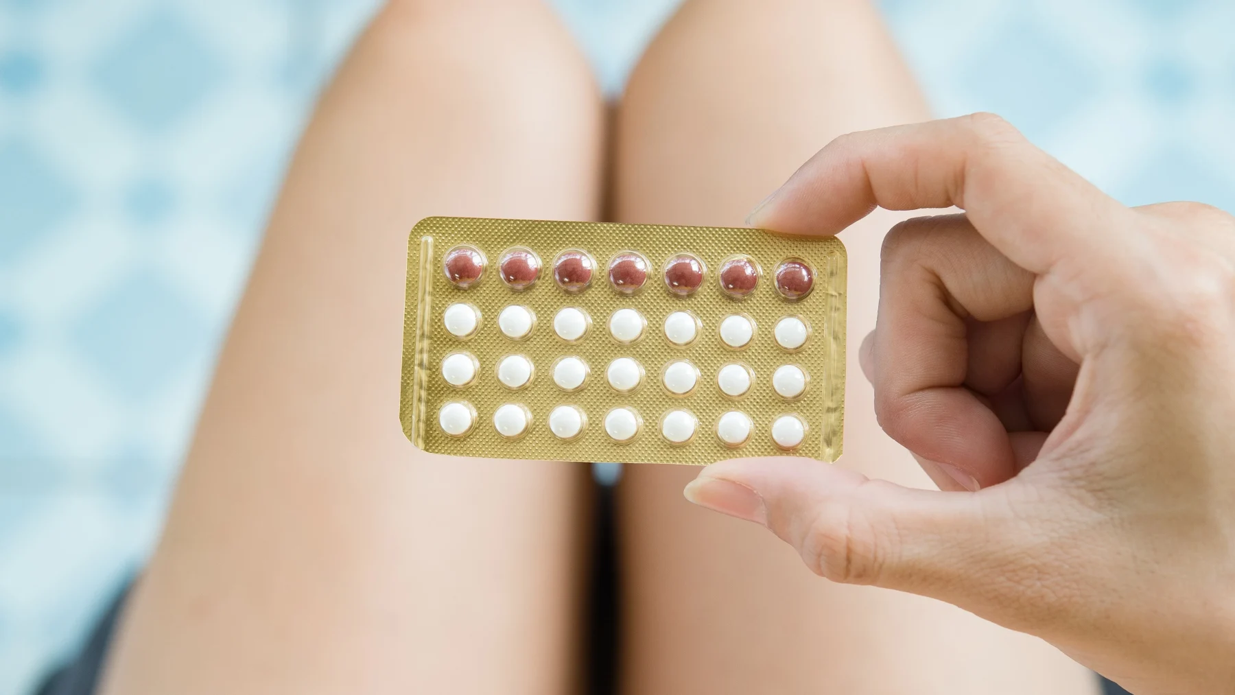 Meisje houdt de anticonceptiepil vast