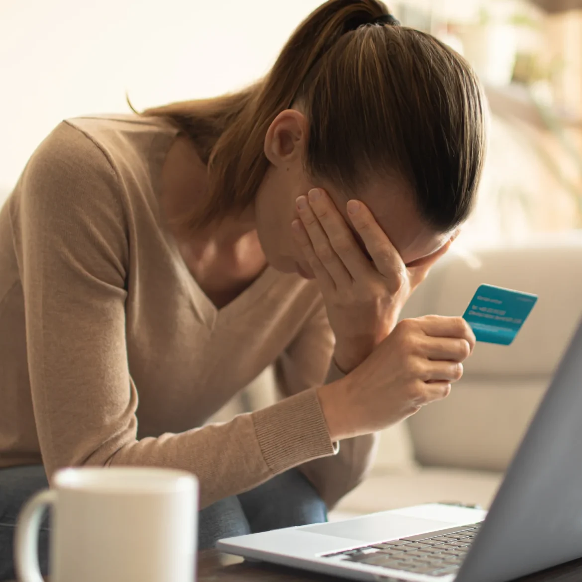 Vrouw houdt bankpas vast en baalt van bank fraude