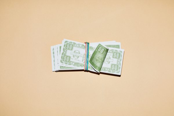 Een pakketje geld op een beige achtergrond