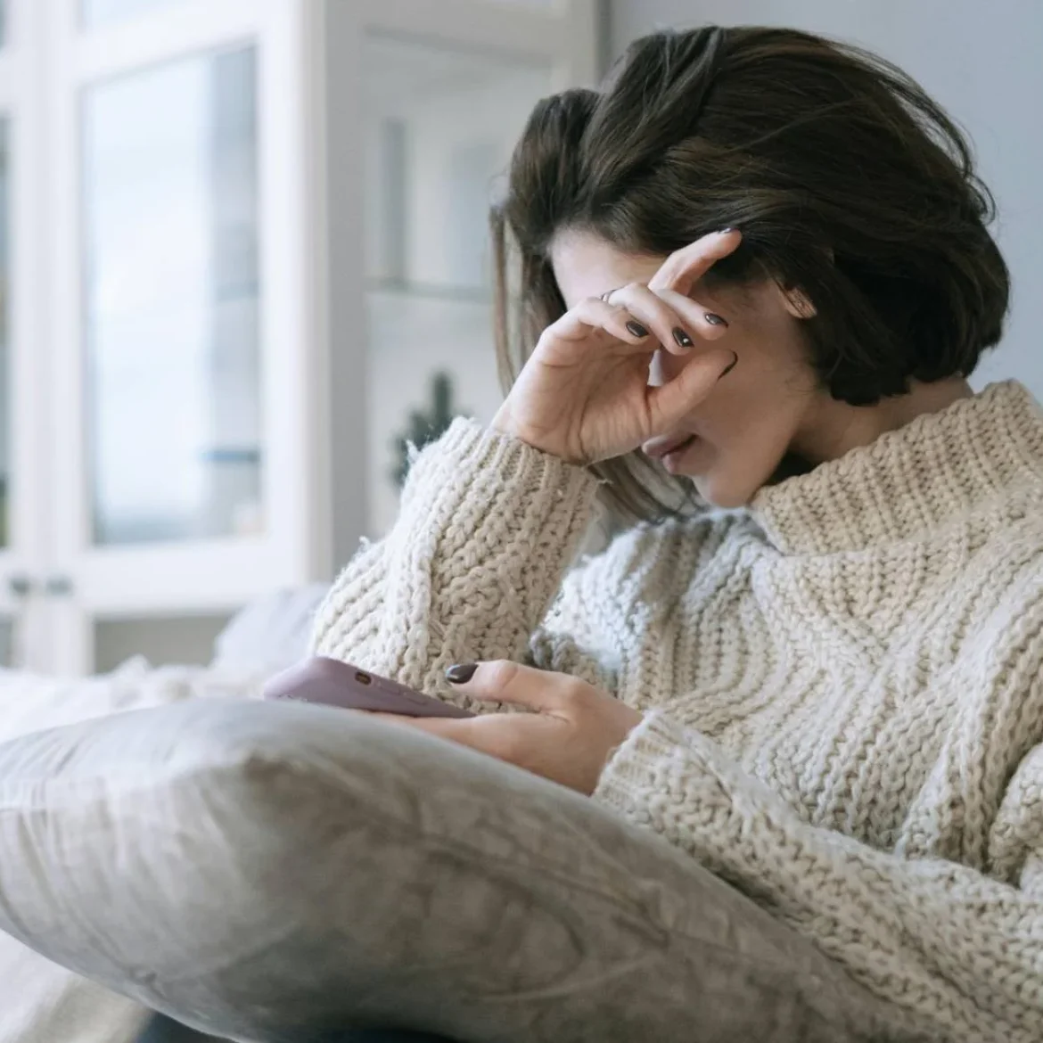 Vrouw huilt met telefoon in hand | Zeldzame stofwisselingsziekte