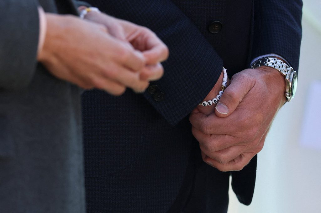 Britain's Prince William, Prince of Wales wears a bracelet bearing Bebe's name, given to him by her Bebe's mother Lauren during a visit to Churchtown Primary School, during a visit to Southport in north-west England on September 23, 2025. 