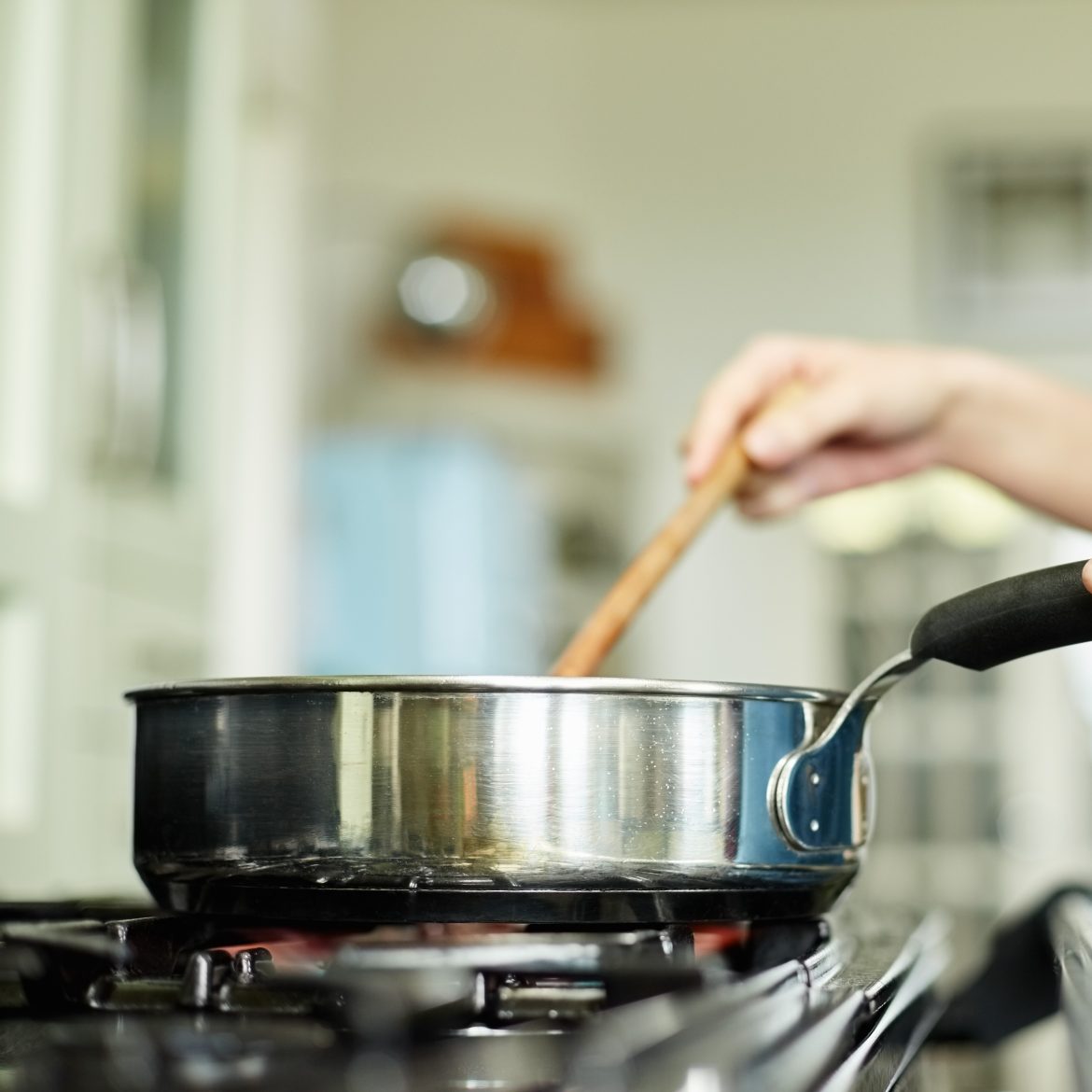 vrouw roert in rvs pan