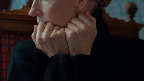 Oude vrouw met handen in gezicht