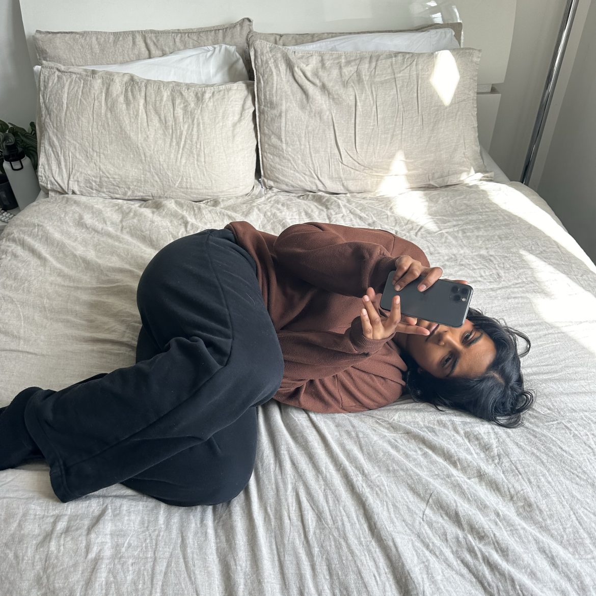 Meid op bed scrollen op telefoon