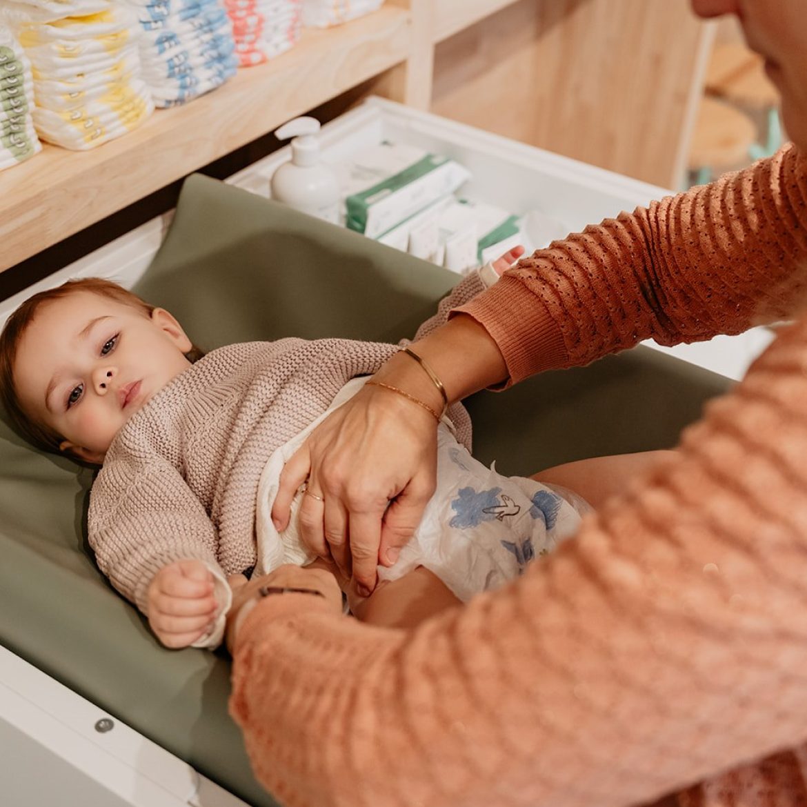 Baby wordt verschoond door moeder.