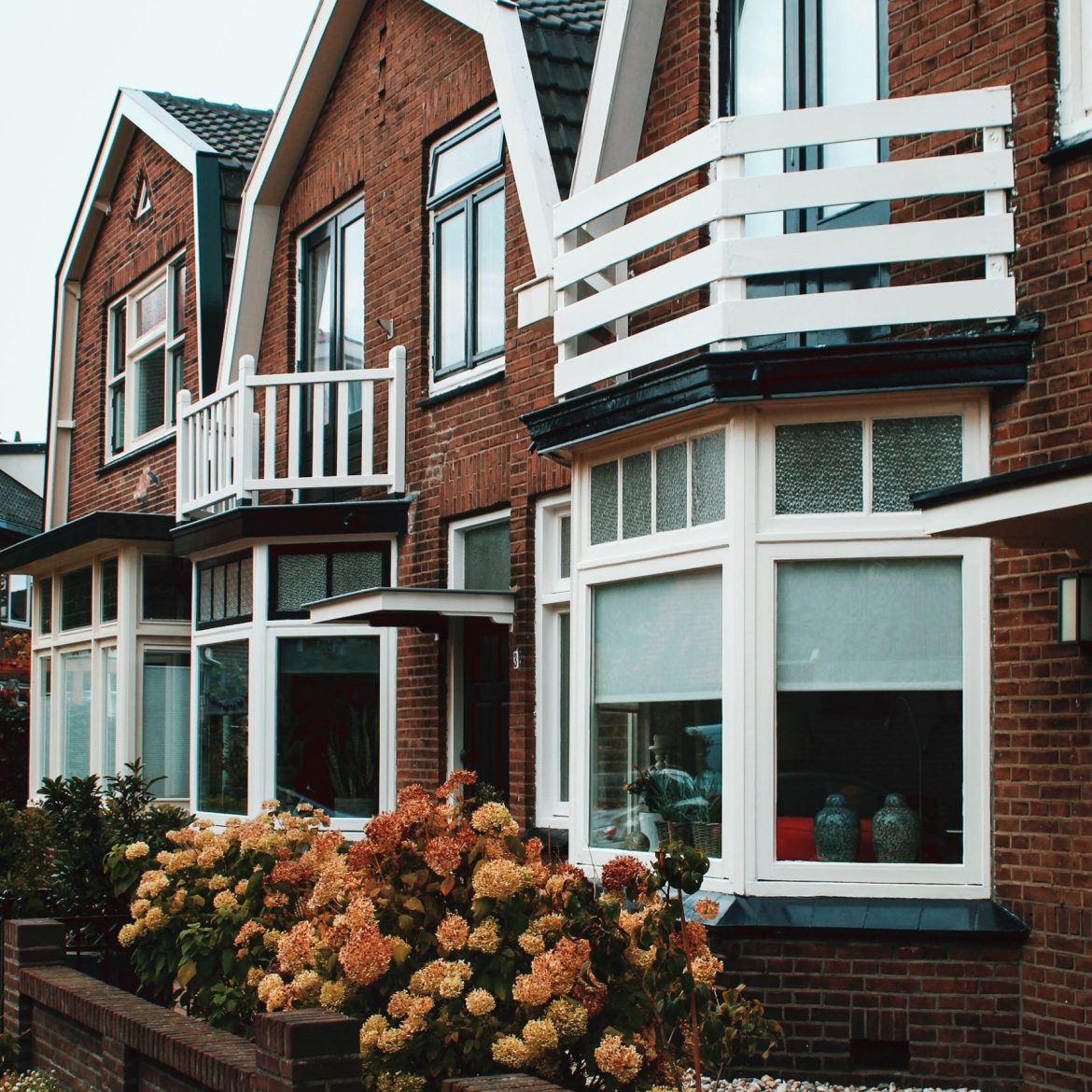 De gevels van een rijtje huizen met erkers